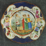 Wall Plate. Young Ladies and a young Sheferd. Over Glasour Painting on Porcelain. D 27 cm